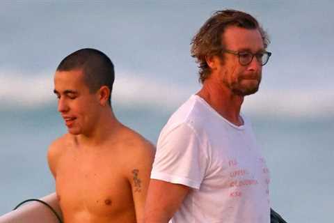 Simon Baker goes into the sea with his son Harry on the beach